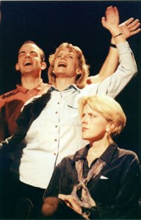 Helen (Jude Salmon, front) feels awkward at a triumphal Christian rally attended by more hardcore worshippers (Roger & Debbie Sutton)  